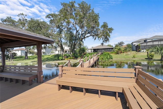 view of dock with a deck with water view