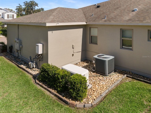 view of property exterior with a yard and cooling unit