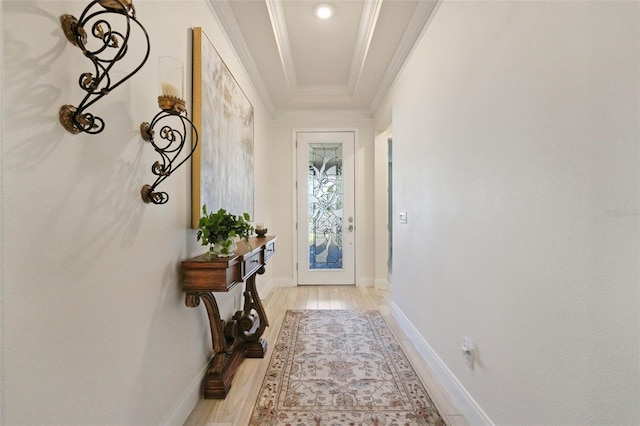 entryway with light hardwood / wood-style floors and crown molding