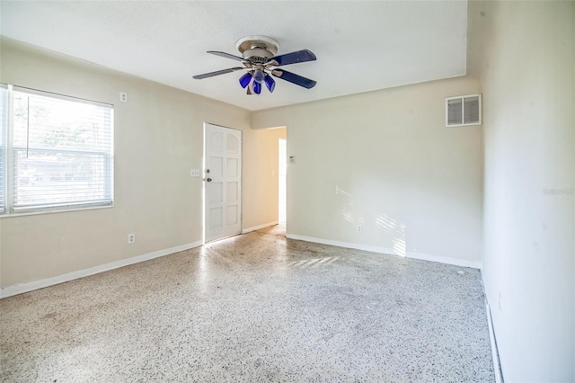 spare room with ceiling fan and a textured ceiling