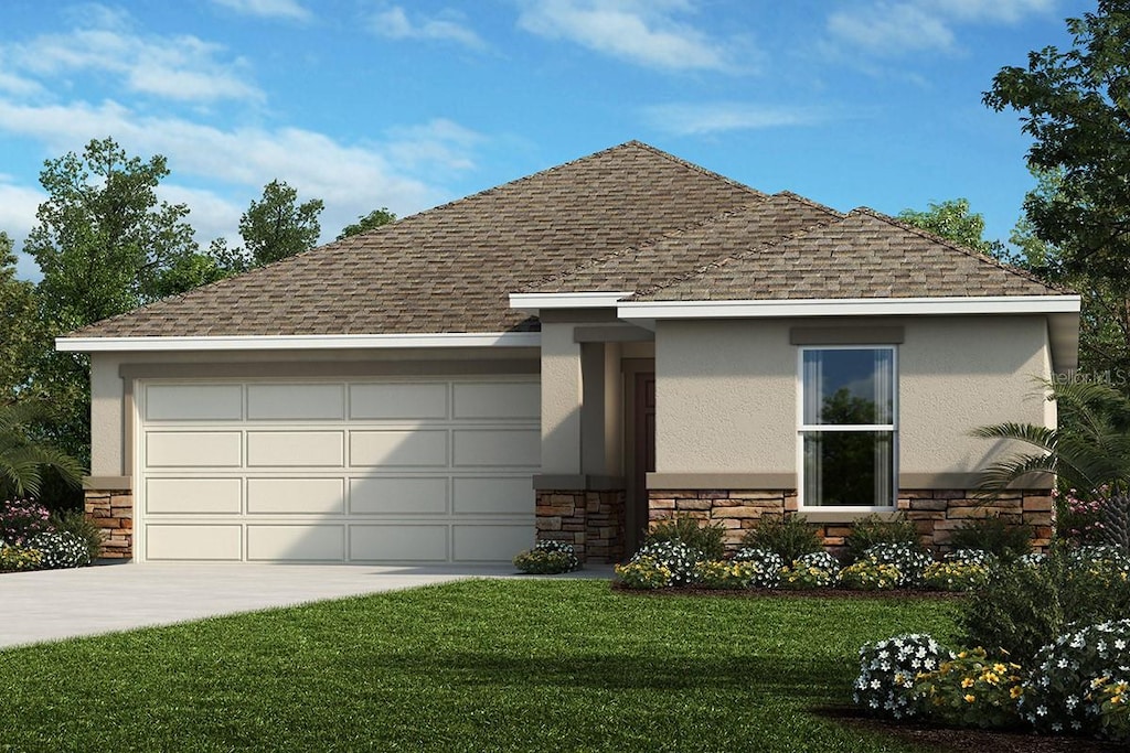 view of front facade with a front lawn and a garage