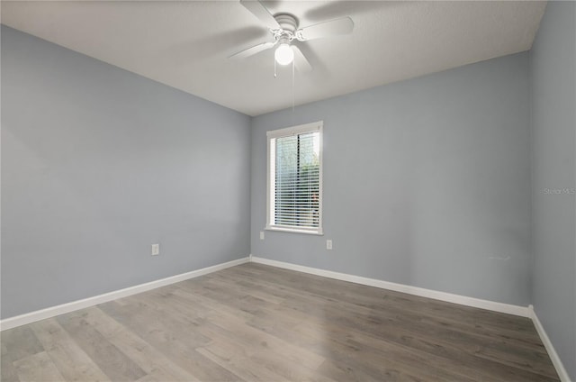 spare room with light hardwood / wood-style floors and ceiling fan