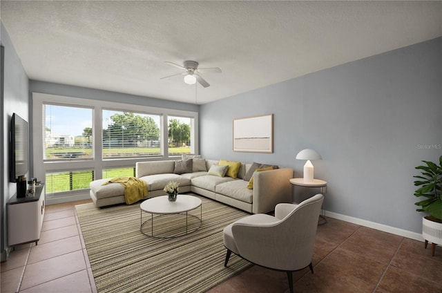 living room featuring ceiling fan and dark tile patterned floors