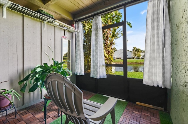 sunroom / solarium with a water view