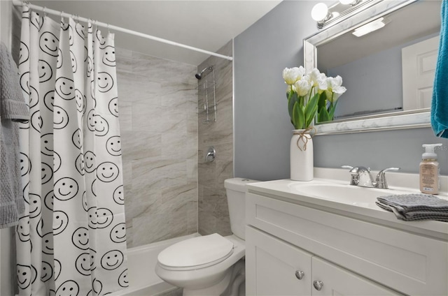 bathroom featuring a tile shower, vanity, and toilet