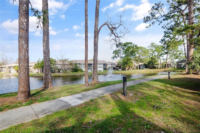 exterior space with a yard, a water view, and a residential view