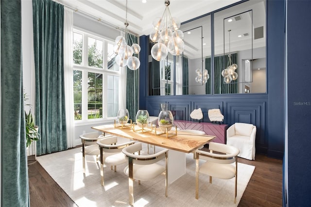 dining area featuring a tray ceiling and wood-type flooring