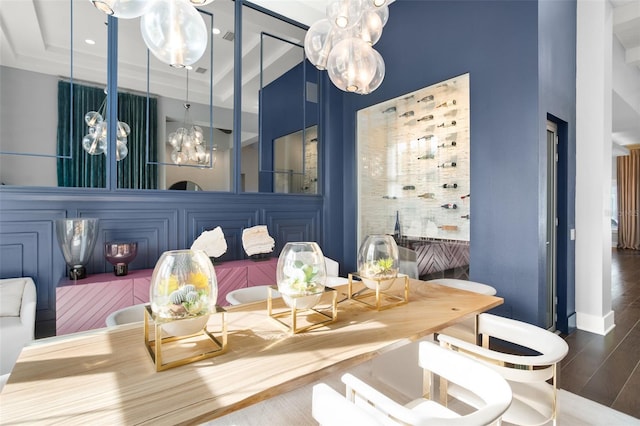 dining space featuring a high ceiling, dark hardwood / wood-style floors, and a raised ceiling