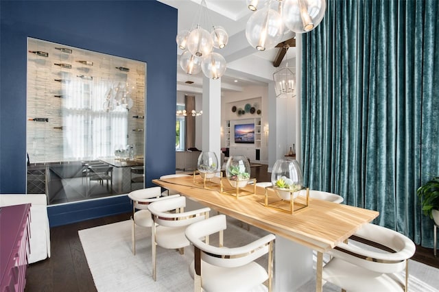 dining room with beamed ceiling, an inviting chandelier, and dark hardwood / wood-style floors