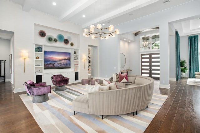 living room featuring a notable chandelier, hardwood / wood-style flooring, beamed ceiling, and built in shelves