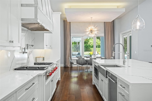 kitchen with hanging light fixtures, premium range hood, white cabinetry, dark wood-type flooring, and light stone counters