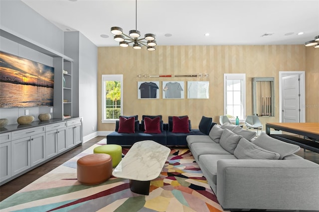 living room with an inviting chandelier and dark hardwood / wood-style flooring