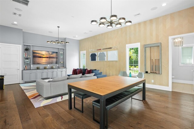 dining space featuring dark wood-type flooring and a chandelier