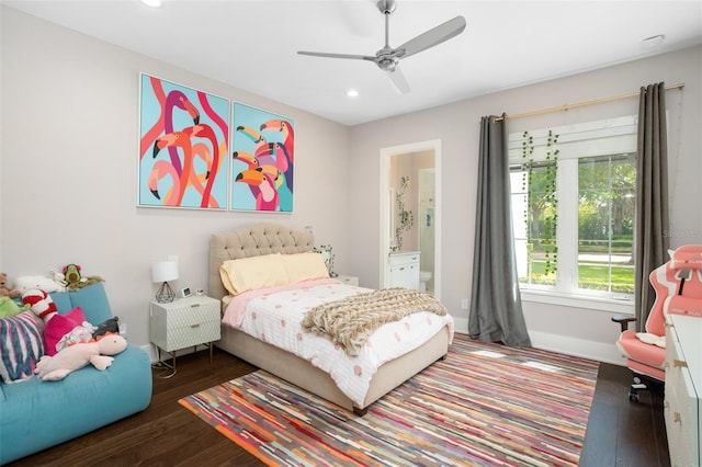 bedroom featuring dark hardwood / wood-style flooring, connected bathroom, and ceiling fan