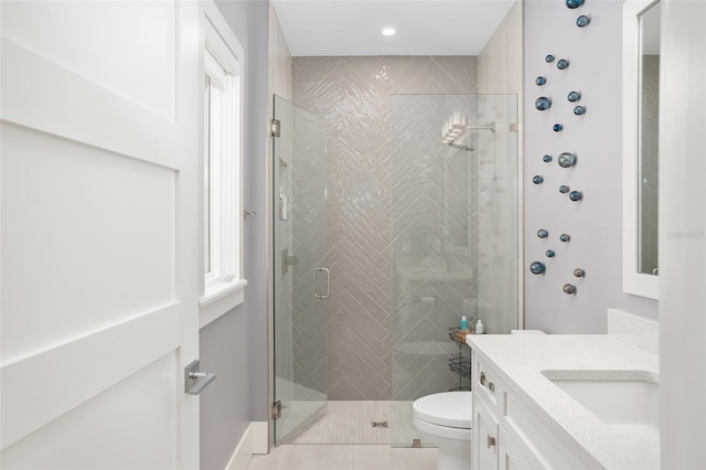 bathroom with vanity, tile patterned flooring, toilet, and an enclosed shower