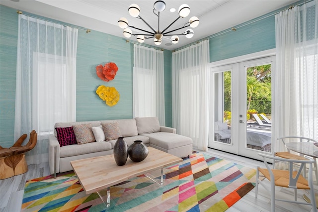 interior space with hardwood / wood-style floors, french doors, and a notable chandelier