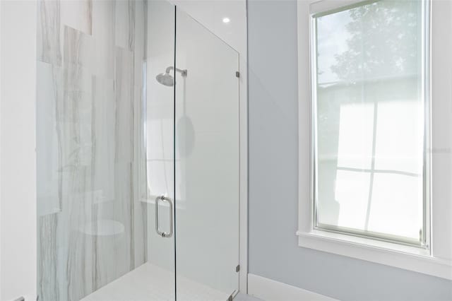 bathroom with a shower with door