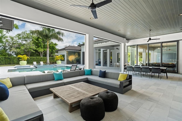 view of patio / terrace with ceiling fan, a fenced in pool, and an outdoor hangout area