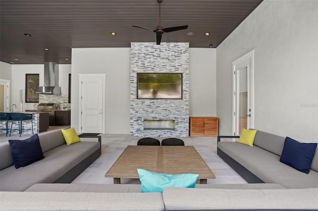 living room featuring a stone fireplace and ceiling fan