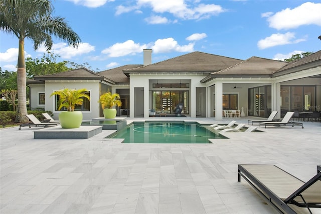 view of pool with a patio and an in ground hot tub