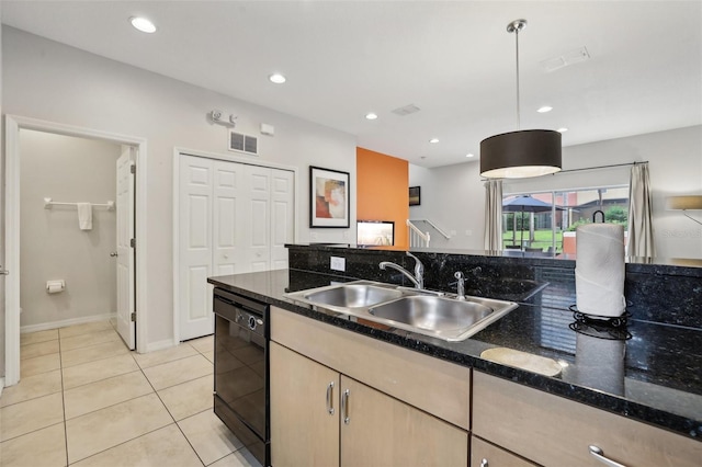 kitchen with dishwasher, light brown cabinets, dark stone countertops, pendant lighting, and light tile patterned floors