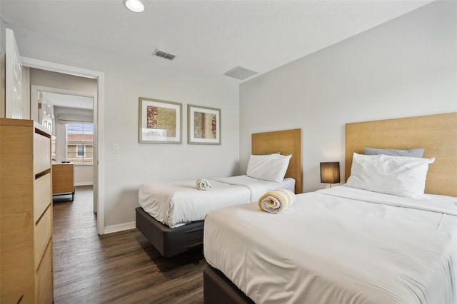 bedroom with dark hardwood / wood-style floors