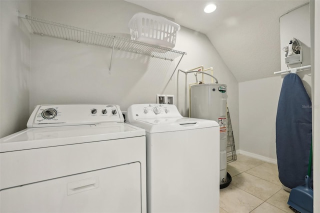 laundry room featuring light tile patterned floors, electric water heater, and separate washer and dryer