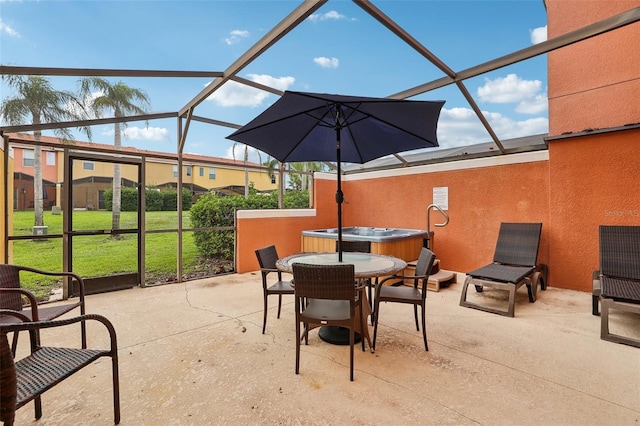 view of patio / terrace featuring a hot tub and a lanai