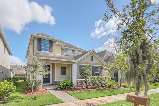 craftsman-style house with a front yard and covered porch