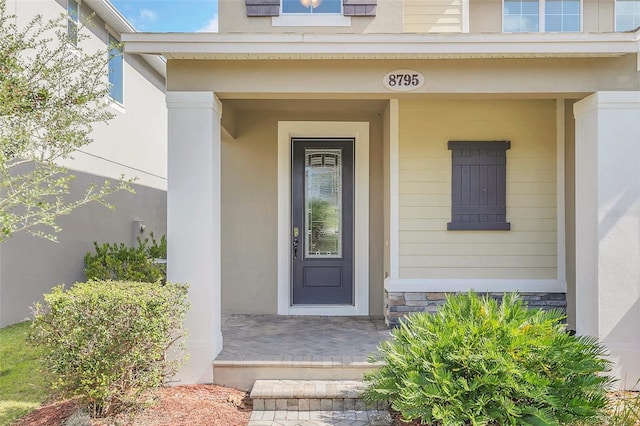 entrance to property featuring covered porch