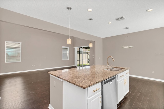 kitchen with white cabinets, light stone counters, a kitchen island with sink, stainless steel dishwasher, and sink