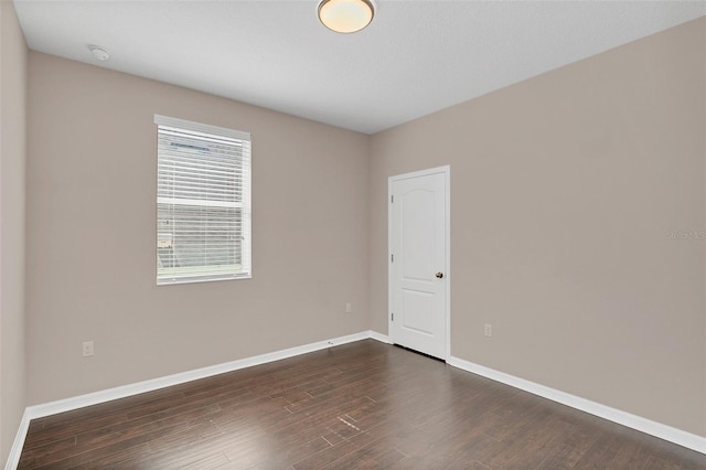 spare room featuring dark hardwood / wood-style floors