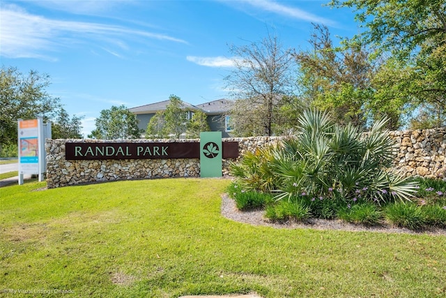 community / neighborhood sign with a yard