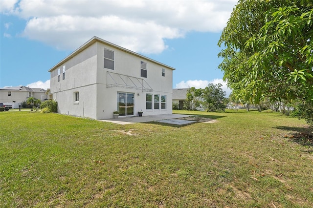 back of house featuring a patio and a yard