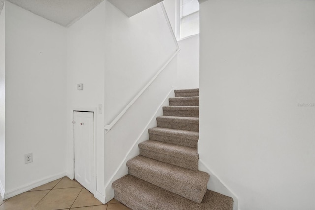 stairs with tile patterned flooring