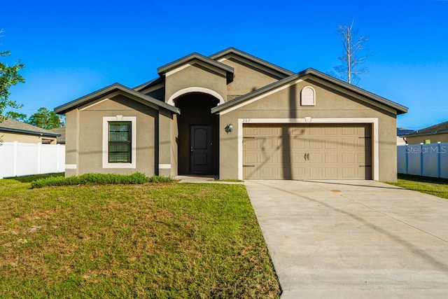 ranch-style home featuring a garage and a front lawn