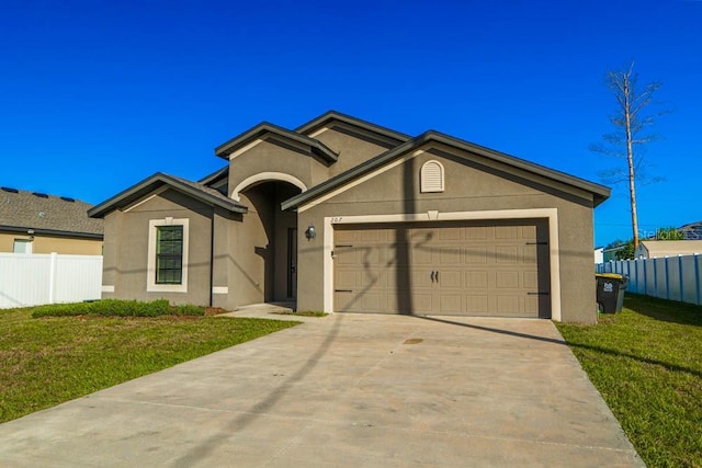 single story home featuring a garage and a front lawn