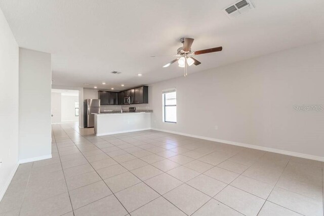 207 Goldenrod Ln, Kissimmee, FL 34759 - unfurnished living room with a ceiling fan, light tile patterned floors, baseboards, and recessed lighting