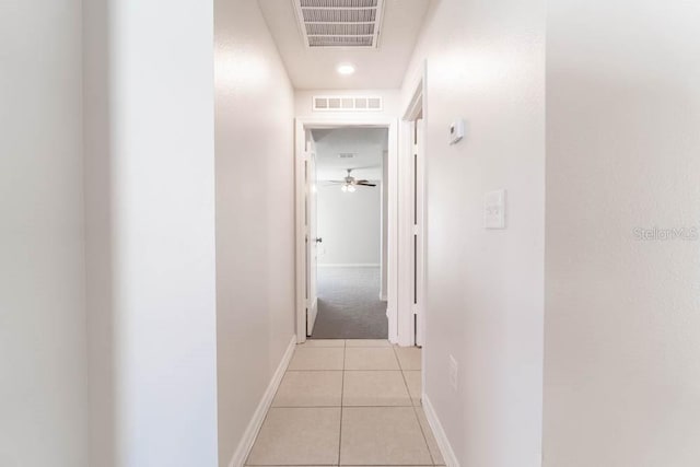 corridor featuring light tile patterned floors