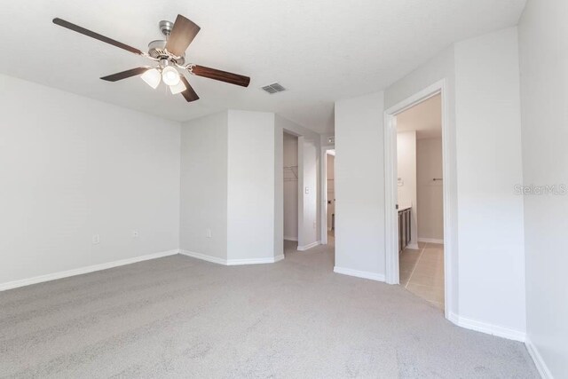 empty room with light carpet and ceiling fan