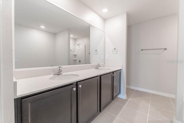 bathroom with vanity, a shower, and tile patterned flooring