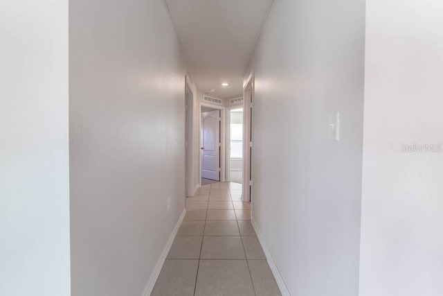 corridor featuring light tile patterned floors