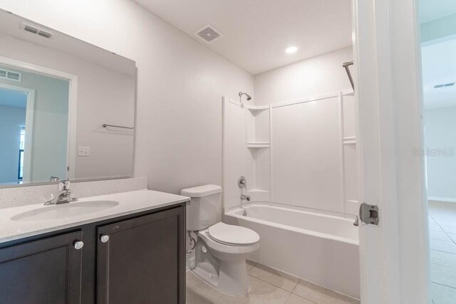 full bathroom featuring vanity, toilet, shower / washtub combination, and tile patterned flooring