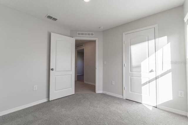 unfurnished bedroom with light carpet