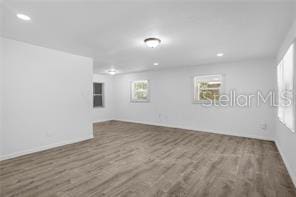 unfurnished room with dark hardwood / wood-style floors