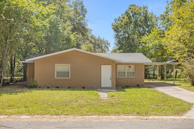 view of front of property with a front lawn and a carport