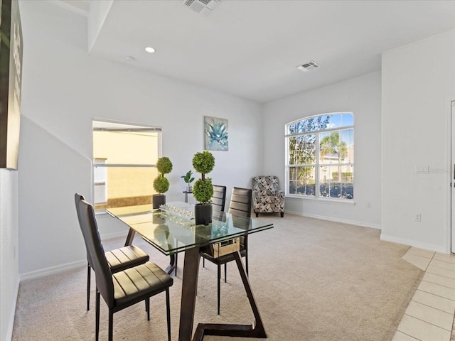 dining space featuring light colored carpet