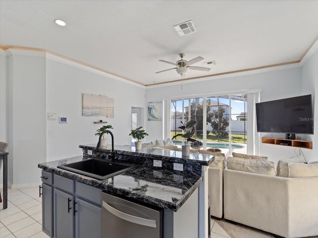 kitchen featuring a kitchen island with sink, stainless steel dishwasher, dark stone counters, ornamental molding, and sink