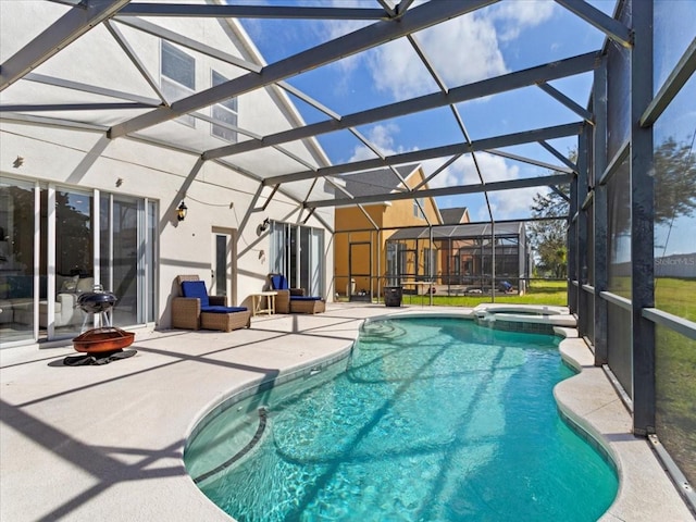 view of pool with a patio area and a lanai