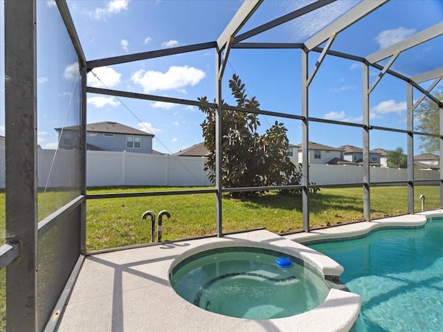 view of pool with an in ground hot tub, a yard, a patio, and a lanai